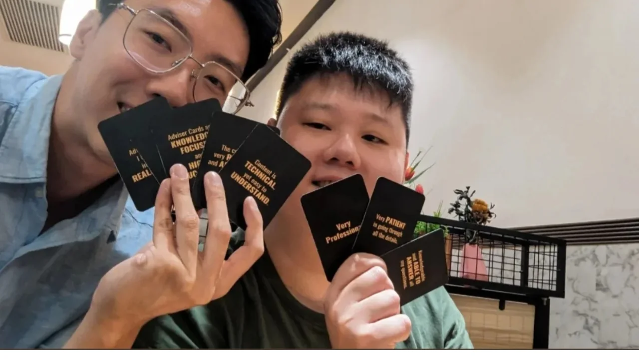 Dennis with a participant holding feedback cards