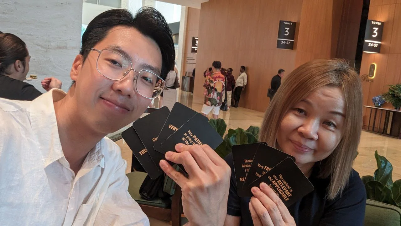 Dennis with a participant holding feedback cards