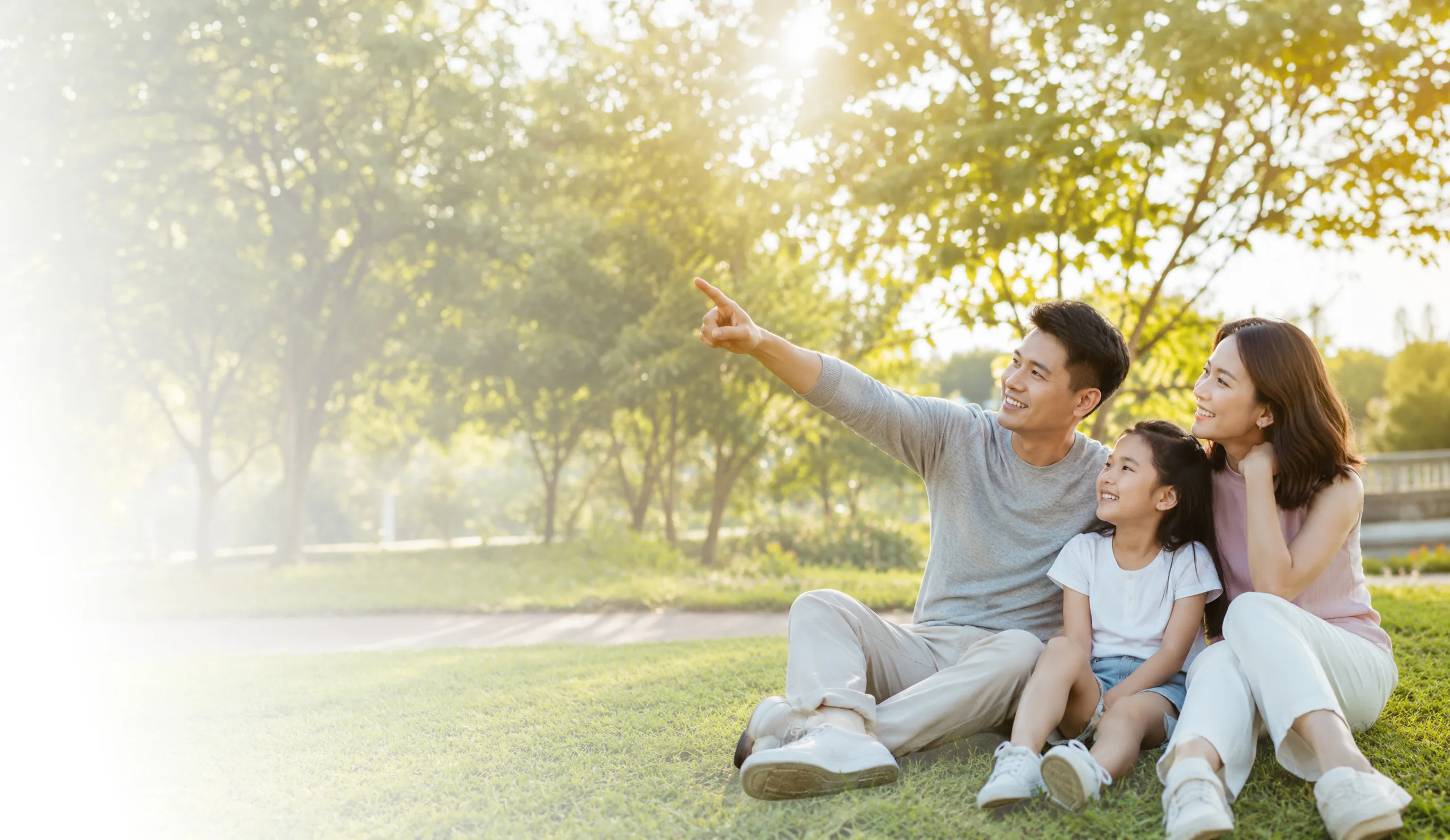 Family spending time together in a sunlit Singapore park